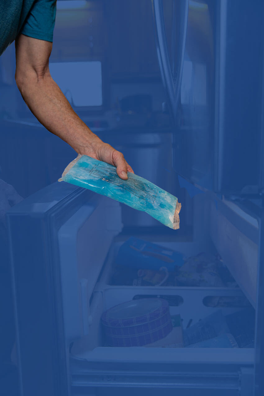 Man taking a frozen SMI gel bag out of the freezer