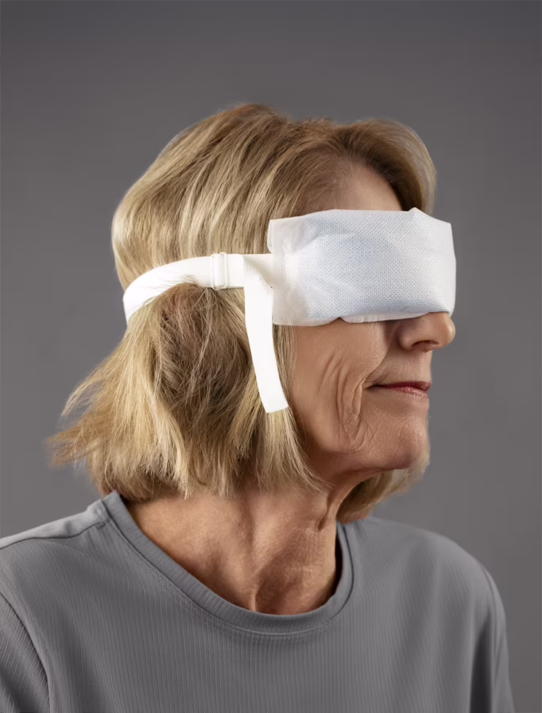 Woman wearing an SMI Cold Therapy Facial Wrap on her eyes