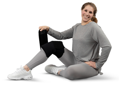 Woman Sitting and Applying an SMI Cold Therapy Knee Warp
